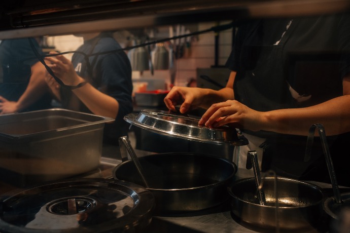 person lifting pot